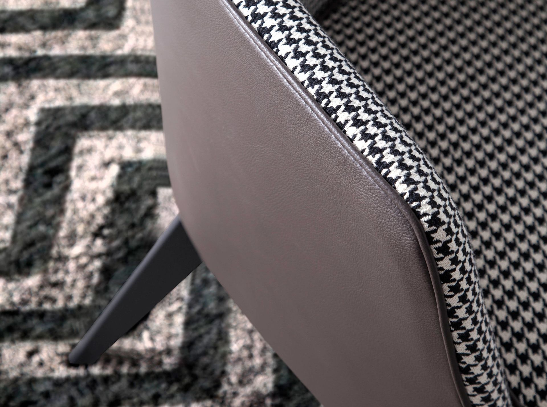 Black and white fabric and chocolate brown leatherette armchair