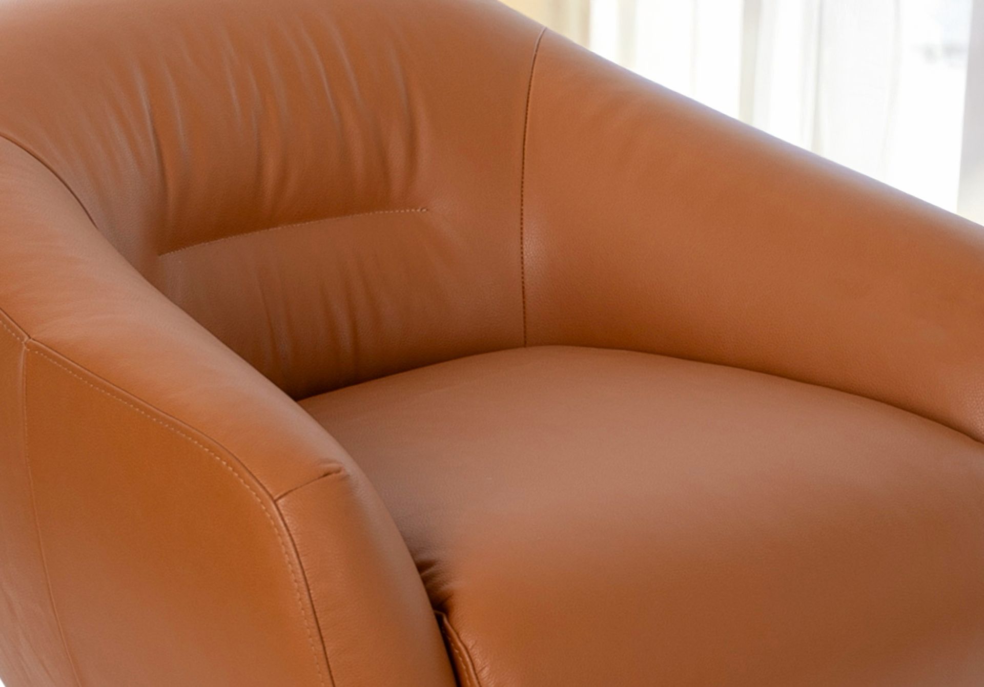Brown leather swivel armchair