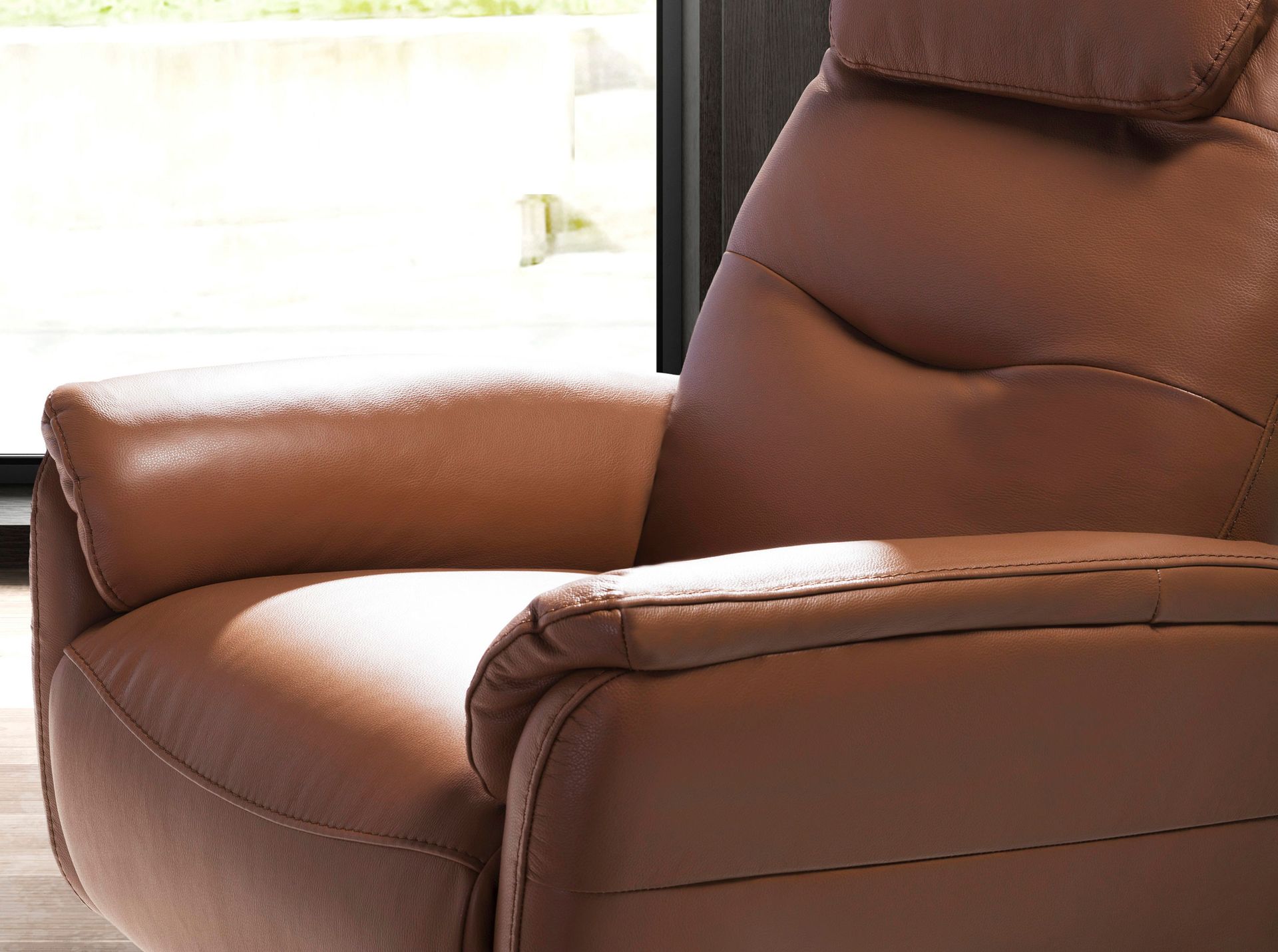 Brown leather swivel armchair