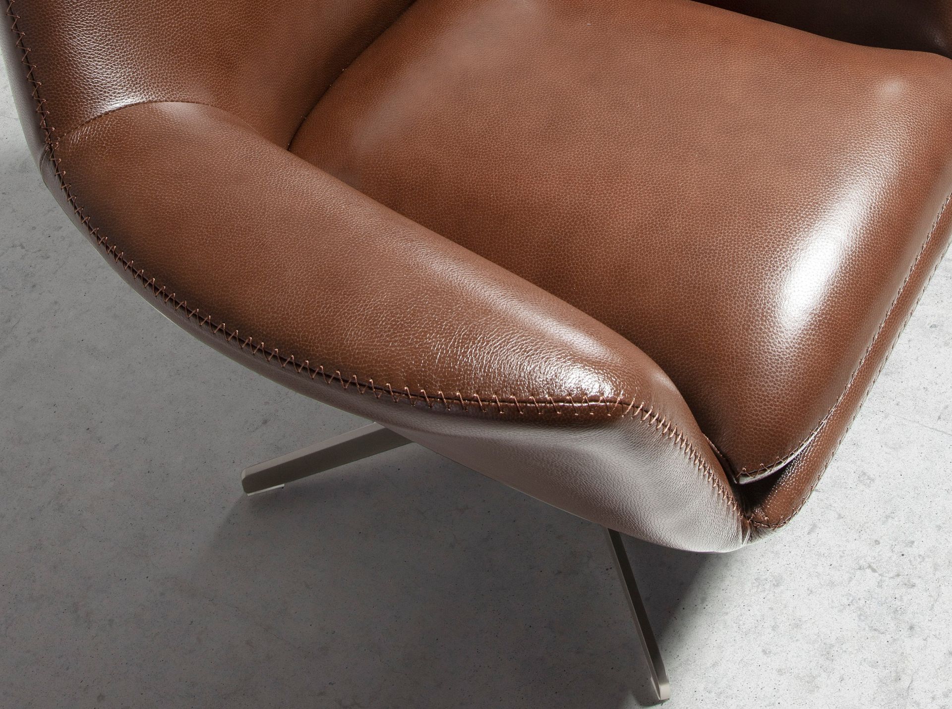 Cognac brown leather swivel armchair