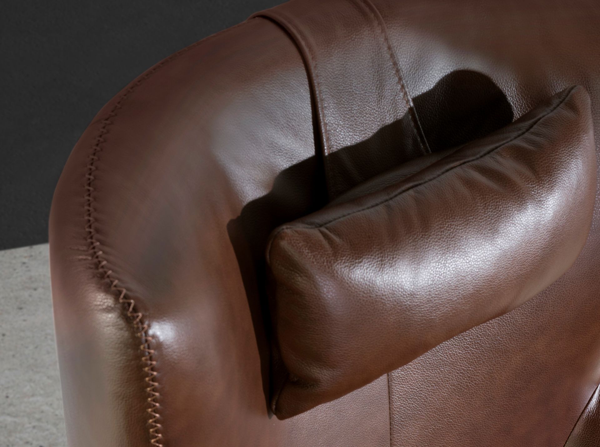 Cognac brown leather swivel armchair