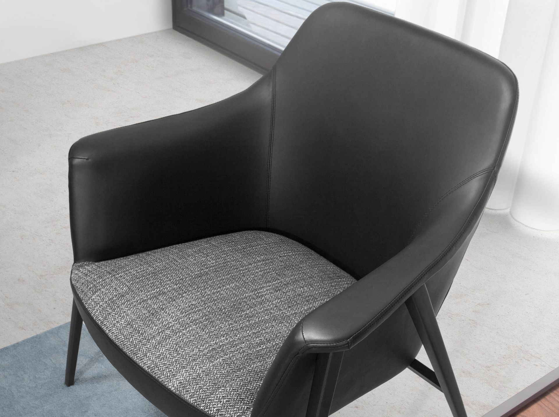 Grey fabric and black leatherette swivel armchair