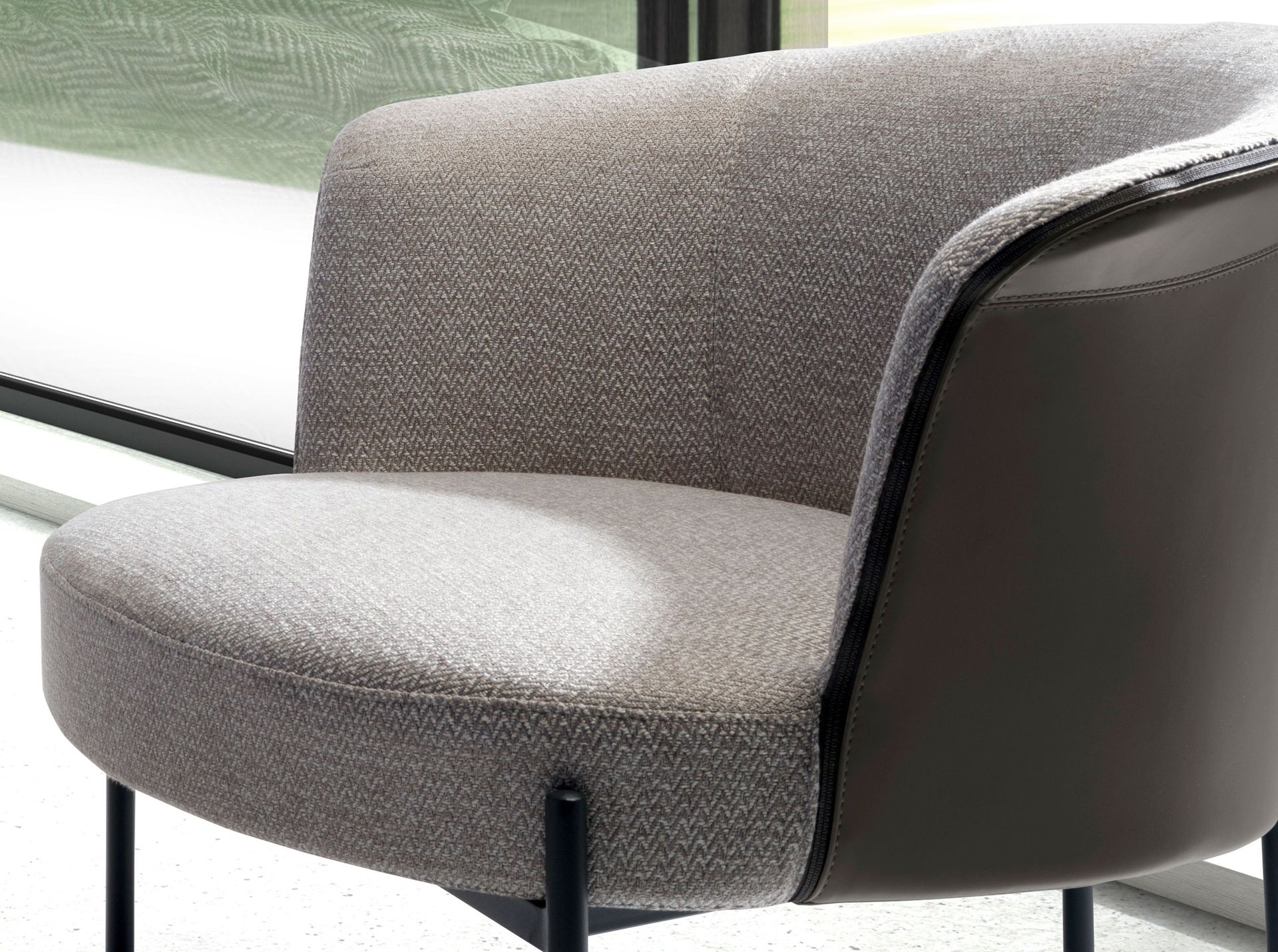 Grey fabric and dark grey leatherette armchair