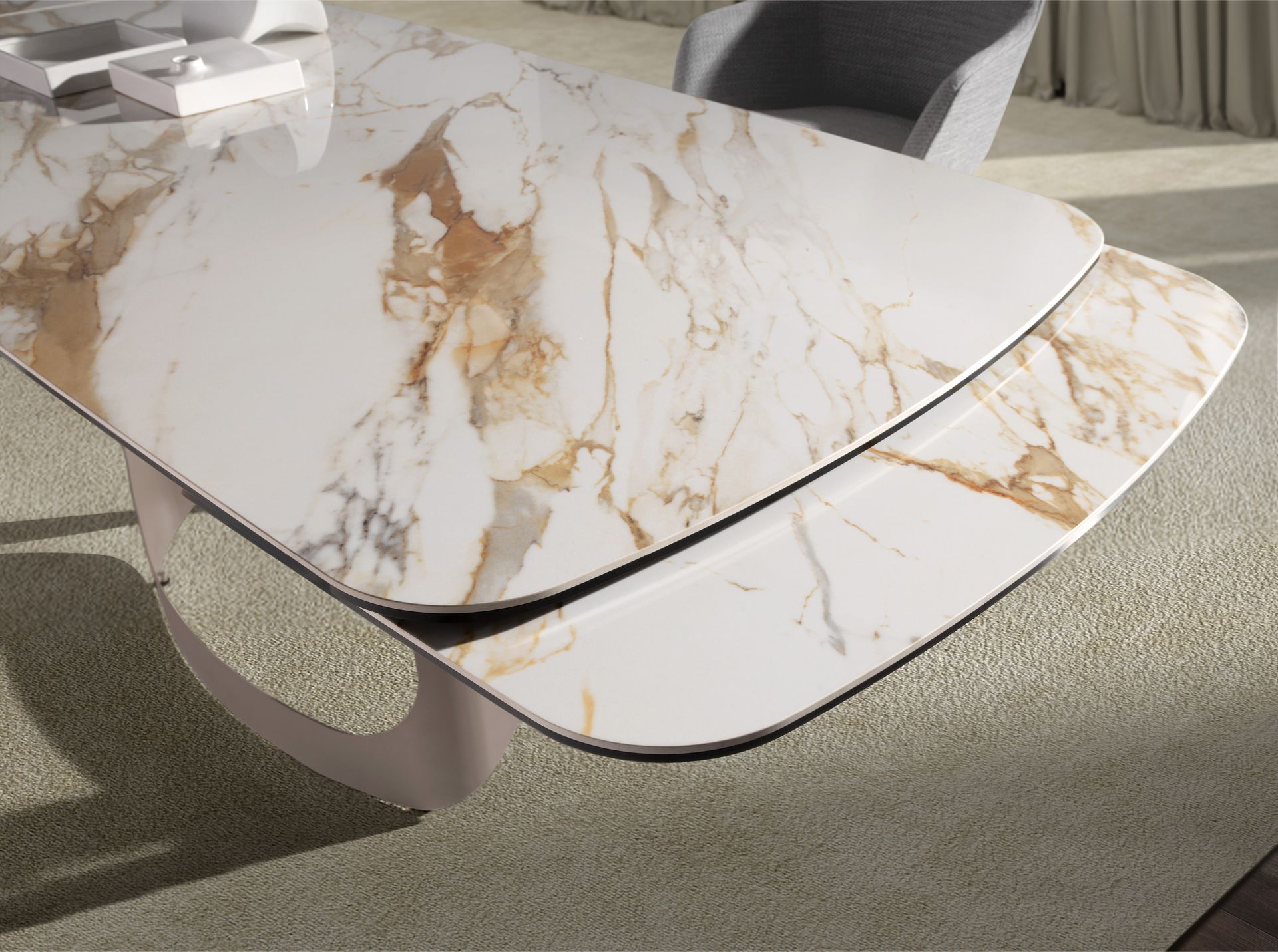 Oval barrel-shaped extendable dining table with porcelain marble and metallic sand steel