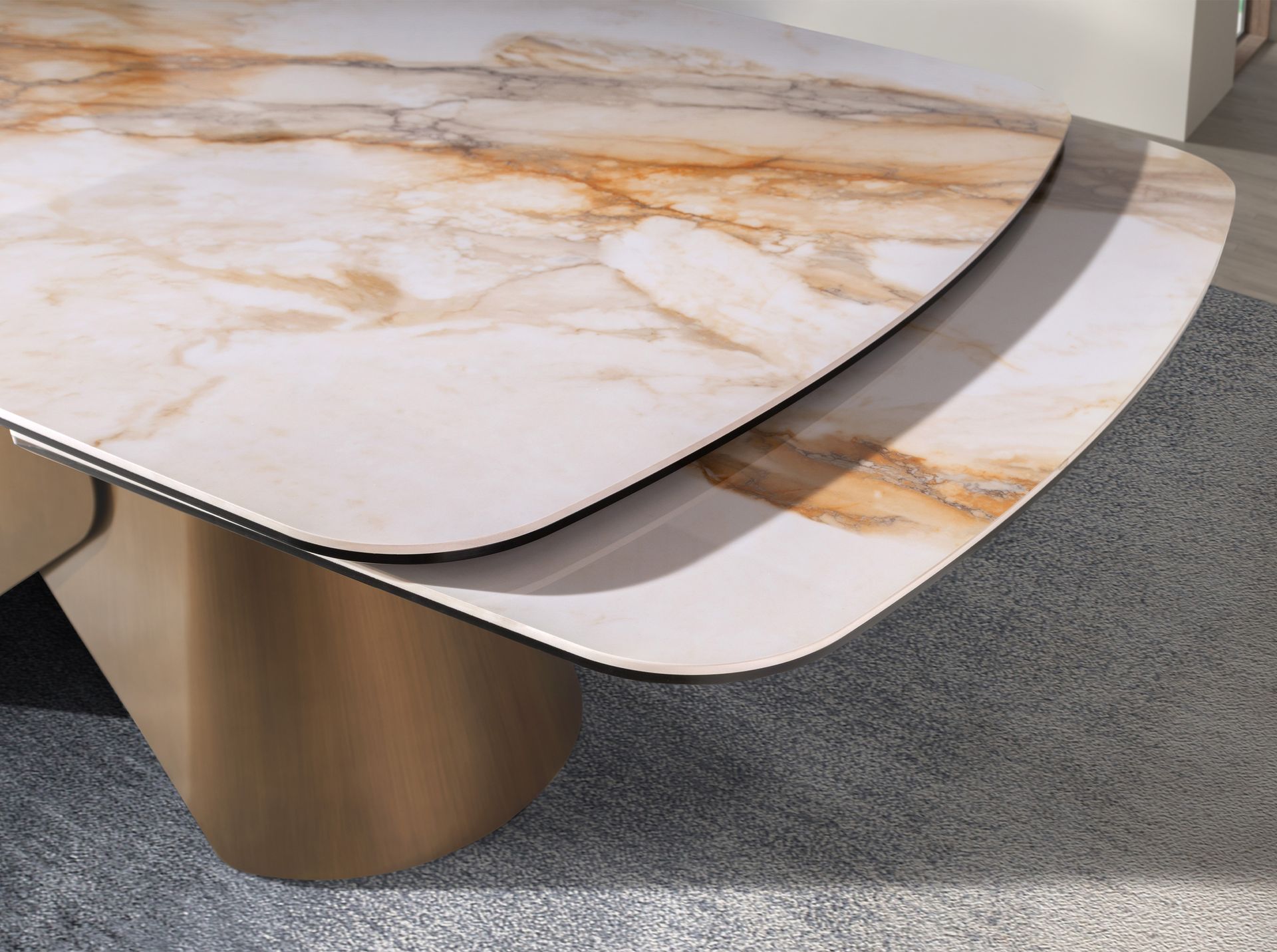 Oval barrel-shaped extendable dining table with porcelain marble top and bronze-coloured steel structure