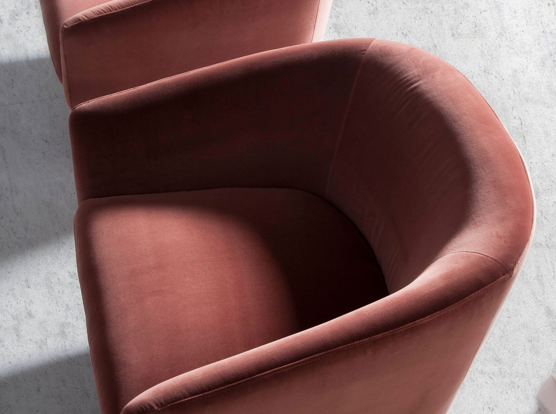 Peach velvet swivel armchair