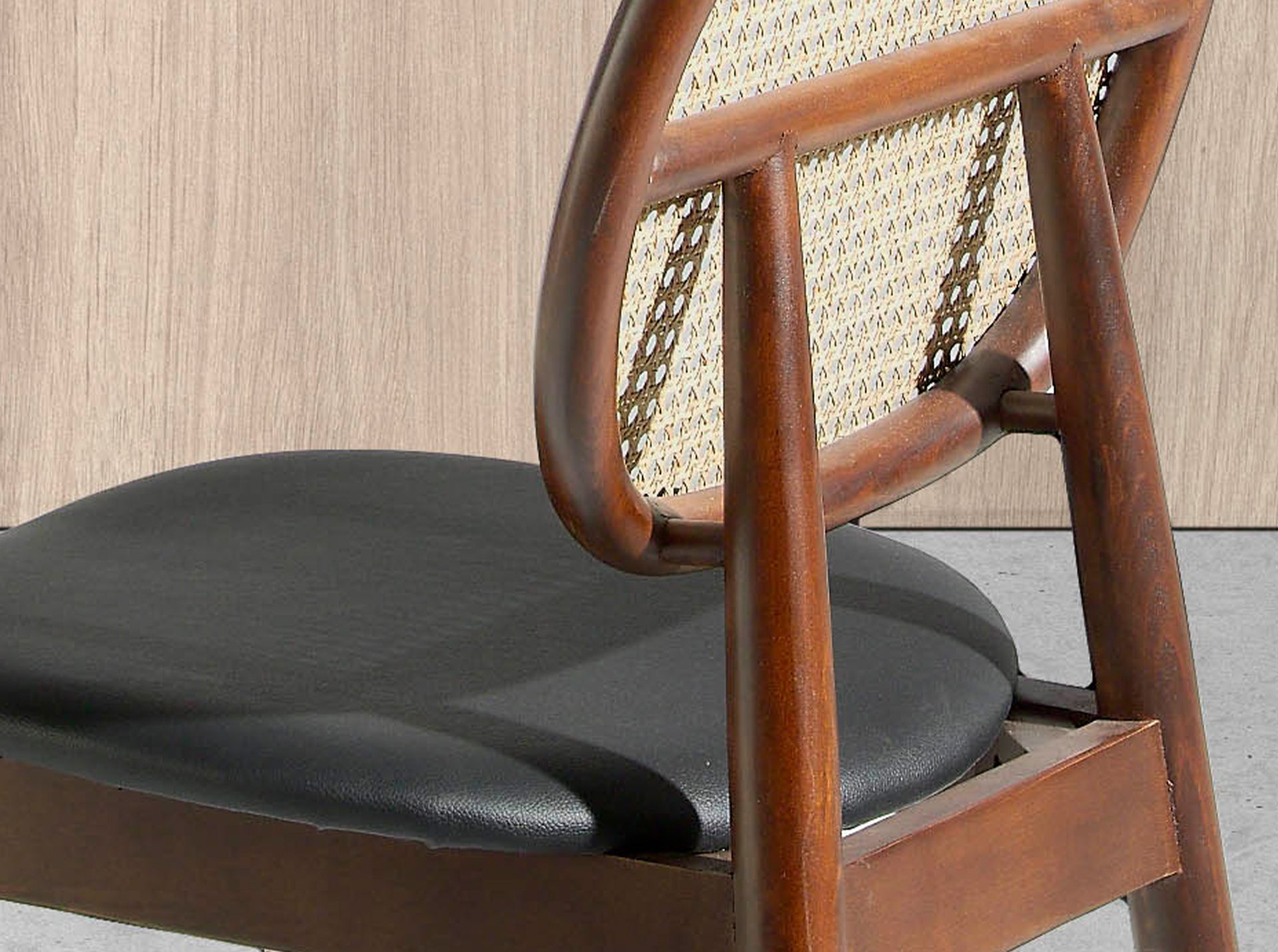Rattan and black leatherette chair