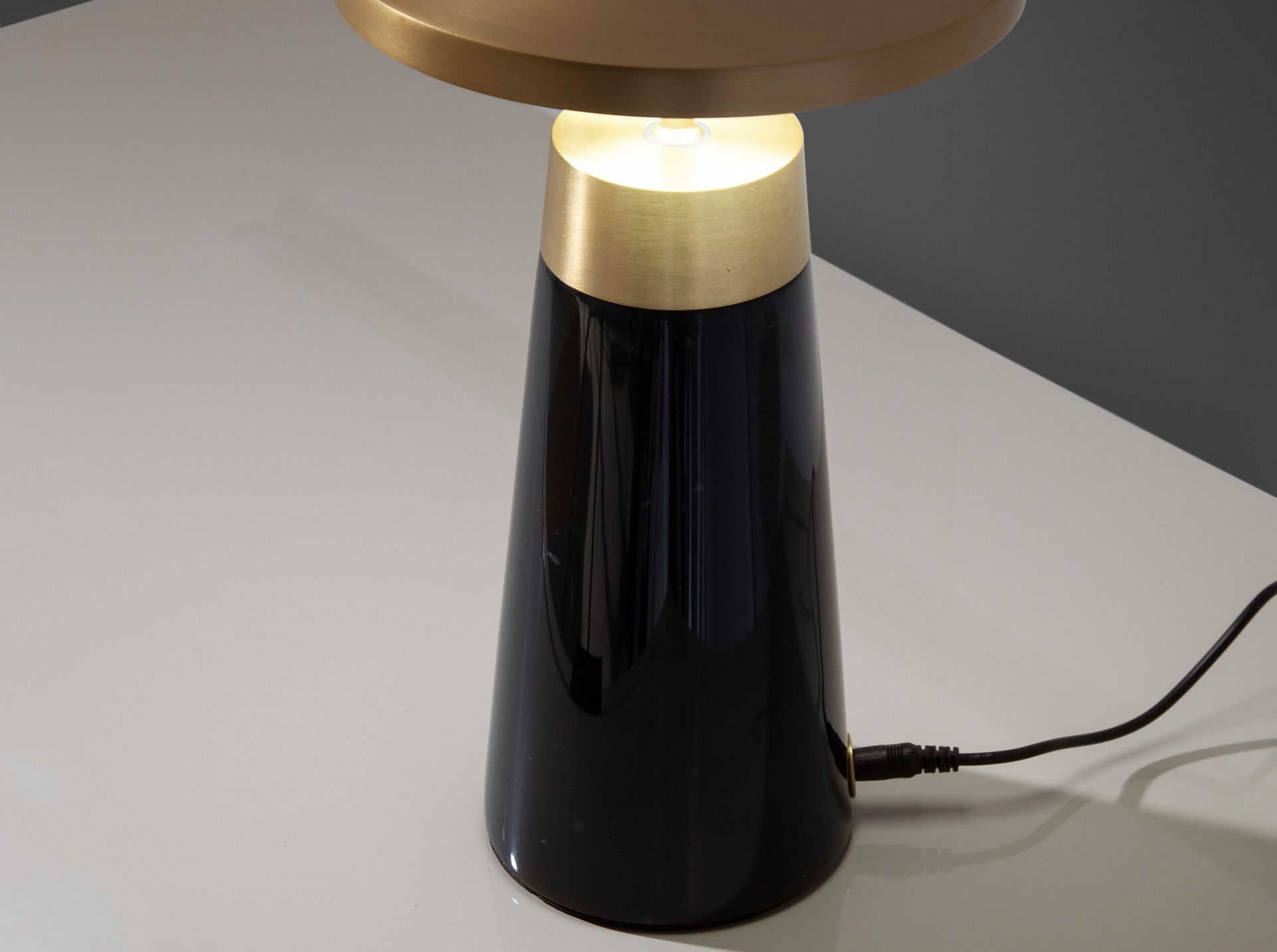 Table lamp in black marble and golden steel